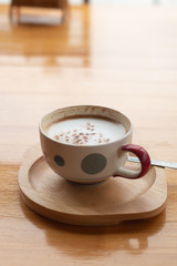 A cup of Latte coffee on wooden desk, Relaxing time or coffee's break time during work day