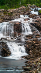 Fototapeta na wymiar A small waterfall near Ersfjorden in Norway