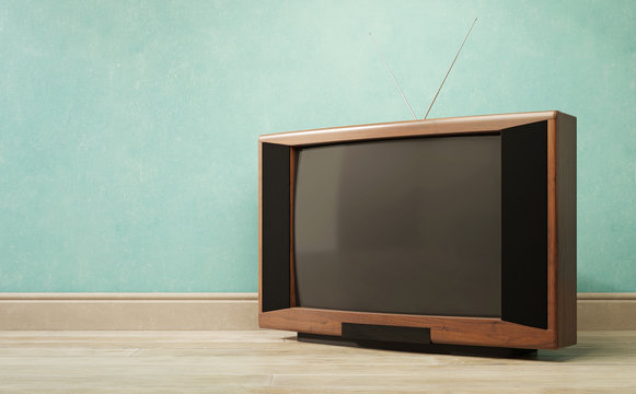 Vintage TV receiver on a green wall background.