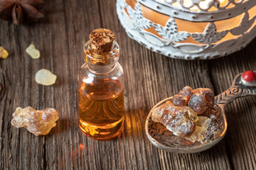 A bottle of frankincense essential oil with frankincense resin