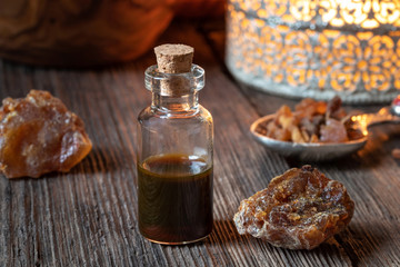 A bottle of myrrh essential oil with myrrh resin crystals