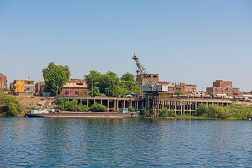 Obraz premium Landscape view of large waterfront industrial area on river nile in Egypt