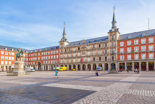 Madrid, Spain. Plaza Mayor: statue of King Philip III and bakery building (Casa de la Panadería)