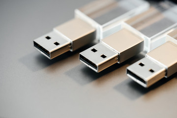 Stylish Flash Drive. Several glass card on a gray background. Macro technology.