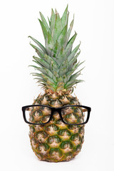 Ripe pineapple with sunglasses on a white background