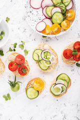 Vegetable mini toast farmer market assorted white baguette vegetables with fish riyette decorated with mini green daikon. Top View