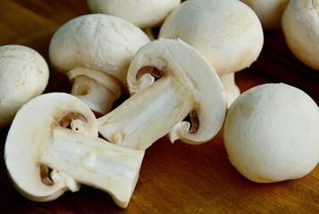 Agaricus bisporus or portobello mushroom on wooden floor.