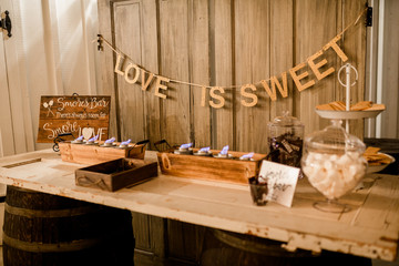 Smores bar table at event with Love is Sweet quote.