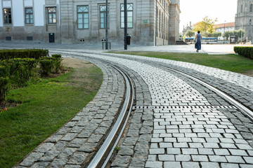 Cityscape: a fragment of a deserted street in Porto with a tram line in the foreground. Copy space.