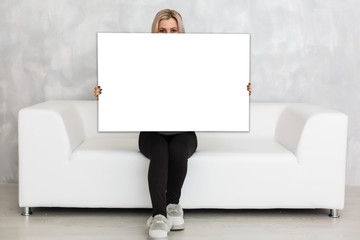 Woman holding a blank board for your text