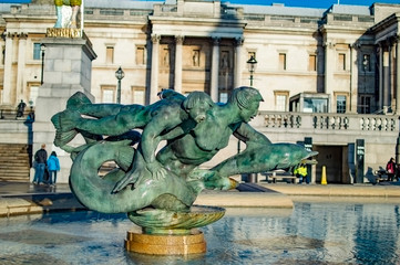 Mermaids, mermen, dolphin and a child sculpture fountain at trafalgar square
