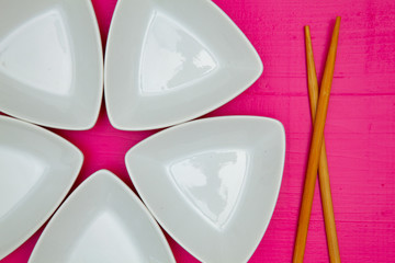 Ceramic bowls  and bamboo chopsticks for sushi food.