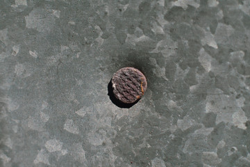 Old iron galvanized roof and rusty nail. © vitold78