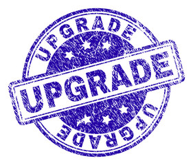 UPGRADE stamp seal imprint with grunge texture. Designed with rounded rectangles and circles. Blue vector rubber print of UPGRADE text with grunge texture.