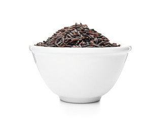 Fototapeta na wymiar Bowl with uncooked black rice on white background