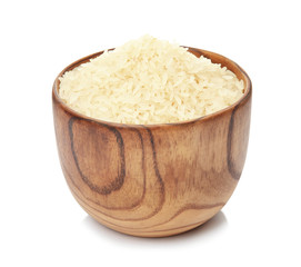 Bowl with uncooked rice on white background