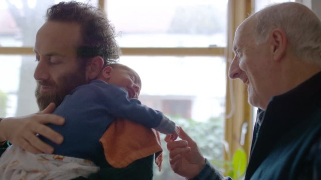 New father and grandfather with newborn baby