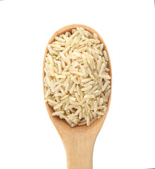 Wooden spoon with brown rice on white background, top view