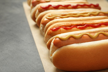 Tasty fresh hot dogs on grey table, closeup. Space for text © New Africa