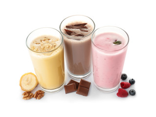 Glasses with different protein shakes and ingredients isolated on white