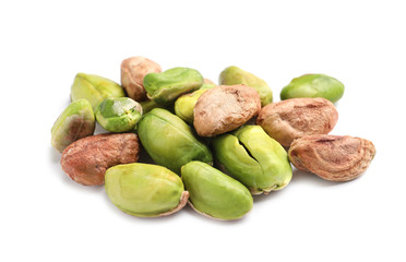 Heap of peeled organic pistachio nuts on white background, closeup