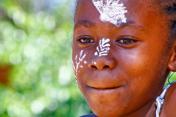 Girl with traditionally painted face, Madagascar
