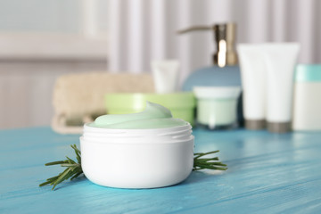 Jar of body care product on table against blurred background. Space for text