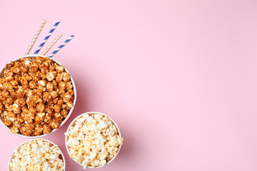 Different kinds of popcorn on color background, top view. Space for text