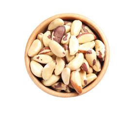 Wooden bowl with Brazil nuts on white background, top view