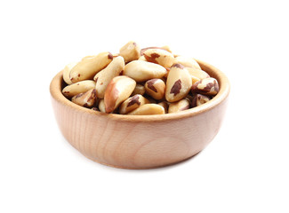 Fototapeta na wymiar Wooden bowl with Brazil nuts on white background