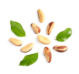 Composition with Brazil nuts and leaves on white background, top view
