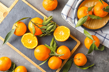 Flat lay composition with ripe tangerines on grey background