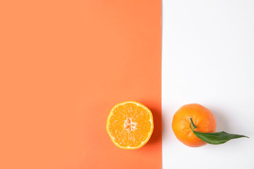 Flat lay composition with ripe tangerines on color background. Space for text