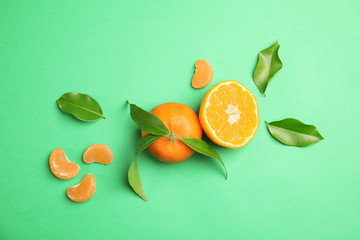 Flat lay composition with ripe tangerines on color background