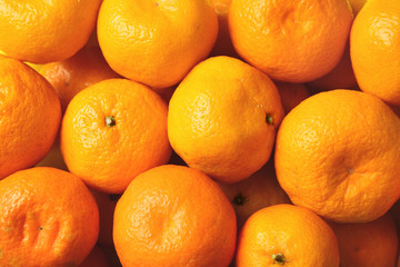 Many ripe tangerines as background, top view