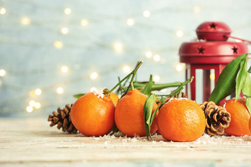 Christmas composition with ripe tangerines and artificial snow on table. Space for text