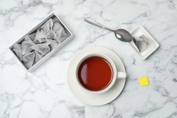 Flat lay composition with delicious hot tea on marble background