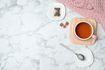 Flat lay composition with delicious hot tea and space for text on marble background