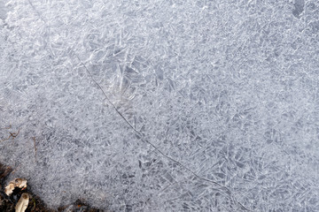 A crack runs through ice crystals in the Little Truckee River, California, USA