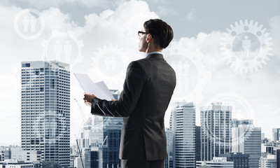 Concept of business success and control with confident boss against cityscape background