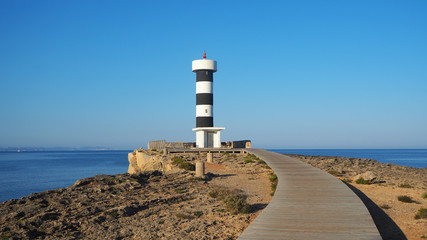 Colonia Sant Jordi, Mallorca, Spain. The lighthouse and the rocks around the village in the morning