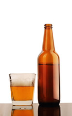 a glass of beer with a brown bottle