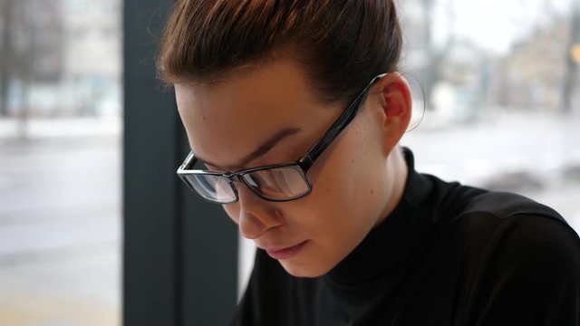 close up shot of a nerd student with glasses