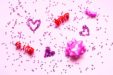 Confetti and stars on pink pastel trendy background. Festive backdrop.