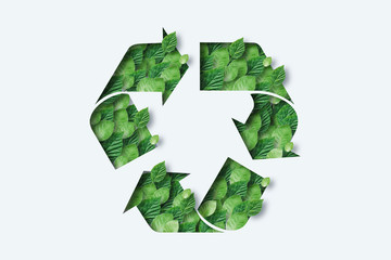 Recycling icon made from green leaves. Light background. The concept of recycling, non-waste production, eco-plastic, eco fuel. - obrazy, fototapety, plakaty