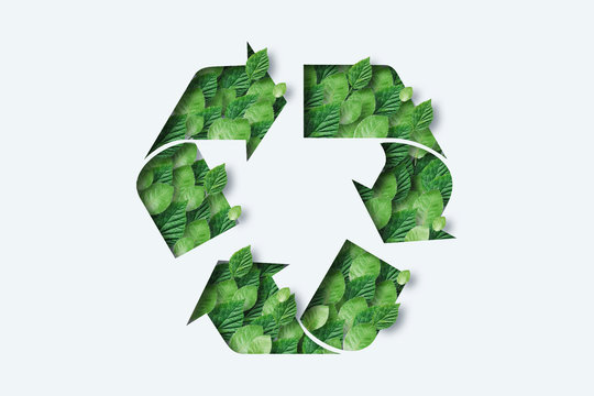Recycling icon made from green leaves. Light background. The concept of recycling, non-waste production, eco-plastic, eco fuel.