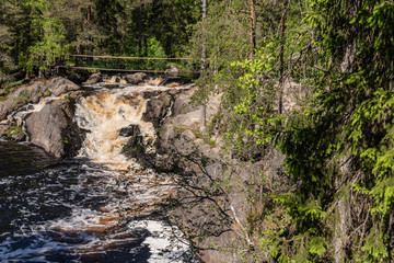 Foamy streams of water Tahmayoki River on the waterfall Ahinkoski