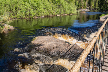 Foamy streams of water Tahmayoki River on the waterfall Ahinkoski