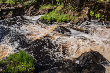 Foamy streams of water Tahmayoki River on the waterfall Ahinkoski