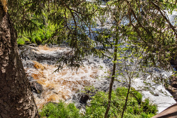 Foamy streams of water Tahmayoki River on the waterfall Ahinkoski